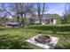 Spacious backyard featuring a fire pit and a well-maintained lawn, ideal for outdoor entertaining at 5836 Andover Rd, Indianapolis, IN 46220