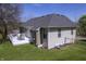 An exterior shot showcasing a well-kept lawn, white back deck, and the home's architectural details at 5836 Andover Rd, Indianapolis, IN 46220