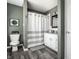 Well-lit bathroom with modern fixtures, stylish vanity, and shower with a curtain at 5836 Andover Rd, Indianapolis, IN 46220