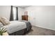 Cozy bedroom featuring neutral decor, plush carpet, and a large window for natural light at 5836 Andover Rd, Indianapolis, IN 46220