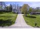 Desirable home featuring pristine landscaping, a long drive, and an attached garage, set on a large lot at 5836 Andover Rd, Indianapolis, IN 46220