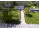 Charming home boasts curb appeal with a well-maintained lawn, mature trees, and a paved driveway at 5836 Andover Rd, Indianapolis, IN 46220