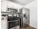 Kitchen showcasing modern stainless steel appliances and ample counter space at 5836 Andover Rd, Indianapolis, IN 46220