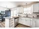 Updated kitchen featuring stainless appliances, a breakfast bar, and stylish white cabinetry at 5836 Andover Rd, Indianapolis, IN 46220