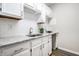 Modern kitchenette features white cabinets, granite countertops, and stainless steel sink at 5836 Andover Rd, Indianapolis, IN 46220