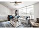 Open-concept living room features a vaulted ceiling, large windows, a ceiling fan, and comfortable seating at 5836 Andover Rd, Indianapolis, IN 46220