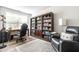 Living room featuring large bookshelf, a comfy armchair, and a desk by the window at 5836 Andover Rd, Indianapolis, IN 46220