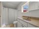 Bright bathroom features a vanity, toilet, and shower with a neutral color palette at 602 Prospect St, Indianapolis, IN 46203