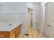 Well-lit bathroom with a vanity, large mirror, and tile flooring, leading to another room at 602 Prospect St, Indianapolis, IN 46203