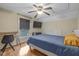 Bedroom with hardwood floors, ceiling fan, desk, and a window offering natural light at 602 Prospect St, Indianapolis, IN 46203