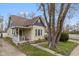 Charming yellow two-story home with purple accents and a well-maintained front yard on a sunny day at 602 Prospect St, Indianapolis, IN 46203
