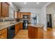 Well-equipped kitchen with wooden cabinets, granite countertops, and a black appliance suite at 602 Prospect St, Indianapolis, IN 46203
