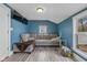 Cozy living room with light-grey floors, a large sectional couch, and two mounted TVs at 602 Prospect St, Indianapolis, IN 46203