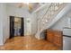 Bright living room features a staircase, compact kitchenette, and convenient washer/dryer units at 602 Prospect St, Indianapolis, IN 46203