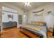 Cozy bedroom with hardwood floors, ceiling fan, and a view into the living room at 602 Prospect St, Indianapolis, IN 46203