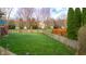 Well-manicured backyard featuring a large grassy area and sturdy wooden fence for privacy at 6043 Acorn Dr, Columbus, IN 47201