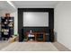 Basement movie area with large screen, white brick and dark fireplace at 6043 Acorn Dr, Columbus, IN 47201