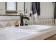 Close up of a bathroom vanity with bronze faucet and decorative tile backsplash at 6043 Acorn Dr, Columbus, IN 47201