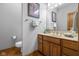Bathroom featuring a single sink vanity with decorative towels and a framed mirror at 6043 Acorn Dr, Columbus, IN 47201
