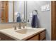 Bathroom sink area showcasing a beige countertop, framed mirror, neutral wall color, and fixtures at 6043 Acorn Dr, Columbus, IN 47201
