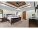 Bright bedroom featuring a coffered wood ceiling with ceiling fan and neutral colored walls and carpet at 6043 Acorn Dr, Columbus, IN 47201