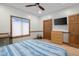 Cozy bedroom featuring a ceiling fan, natural light, a workspace, and a closet for storage at 6043 Acorn Dr, Columbus, IN 47201