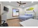 Inviting bedroom with a ceiling fan and large window providing natural light, complemented by a desk area at 6043 Acorn Dr, Columbus, IN 47201