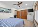 Bright bedroom features a ceiling fan, closet, a white desk and a mounted TV at 6043 Acorn Dr, Columbus, IN 47201