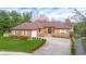 Charming brick home with a well-manicured lawn, inviting entrance, and a spacious driveway at 6043 Acorn Dr, Columbus, IN 47201