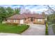Charming brick home with a well-manicured front lawn and a spacious driveway, providing ample parking at 6043 Acorn Dr, Columbus, IN 47201