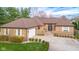 Charming brick home with a well-manicured lawn, inviting entrance, and a spacious driveway at 6043 Acorn Dr, Columbus, IN 47201