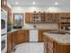 Bright kitchen with wooden cabinets, granite countertops, and updated appliances at 6043 Acorn Dr, Columbus, IN 47201