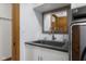 Laundry sink featuring mirror with mosaic-style border and door to closet at 6043 Acorn Dr, Columbus, IN 47201