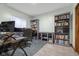 Well-lit home office featuring a built-in bookcase and computer desk at 6043 Acorn Dr, Columbus, IN 47201