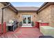 Outdoor kitchen on the deck with grill, serving counter, and convenient access through glass doors at 6043 Acorn Dr, Columbus, IN 47201