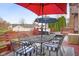 Outdoor seating on wooden deck with colorful umbrellas for shade at 6043 Acorn Dr, Columbus, IN 47201