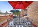 Outdoor seating on wooden deck with colorful umbrellas and barbecue grill at 6043 Acorn Dr, Columbus, IN 47201
