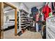 Spacious walk-in closet featuring custom shelving, shoe racks, and ample storage for organization and bedroom view at 6043 Acorn Dr, Columbus, IN 47201