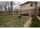 Backyard scene with a pile of firewood, fire pit and patio area at 63 Park Forest N Dr, Whiteland, IN 46184