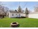 Spacious backyard showcasing a fire pit and well-manicured lawn at 6721 Evanston Ave, Indianapolis, IN 46220