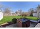 View of the backyard with well-maintained lawn and patio set at 6721 Evanston Ave, Indianapolis, IN 46220