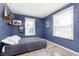Bedroom with blue walls, bed, and natural light coming from two windows at 6721 Evanston Ave, Indianapolis, IN 46220