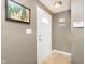 Inviting entryway with a white front door, tile flooring, and stylish wall decor at 6721 Evanston Ave, Indianapolis, IN 46220