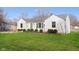 Classic single-story home with green lawn, showcasing the clean white facade and natural light from the windows at 6721 Evanston Ave, Indianapolis, IN 46220