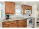 Bright kitchen featuring granite countertops, wooden cabinets, and modern appliances at 6721 Evanston Ave, Indianapolis, IN 46220