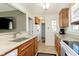 Functional kitchen with granite counters, wood cabinets, and a view to the hallway at 6721 Evanston Ave, Indianapolis, IN 46220