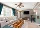 Cozy living room with a comfortable couch, a ceiling fan, and a view to the entryway at 6721 Evanston Ave, Indianapolis, IN 46220