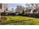 Backyard with grassy area, utility shed, and a tall privacy fence at 7021 Warwick Rd, Indianapolis, IN 46220