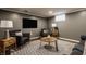 Finished basement with neutral tones, recessed lighting, comfortable seating at 7021 Warwick Rd, Indianapolis, IN 46220