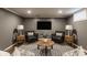 Finished basement area with neutral tones, recessed lighting, and two chairs at 7021 Warwick Rd, Indianapolis, IN 46220
